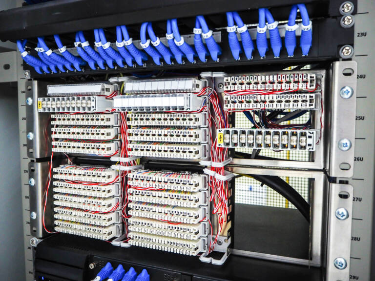 wired industrial control panel with organized circuits and components, representing disciplined OT design and resilient system architecture