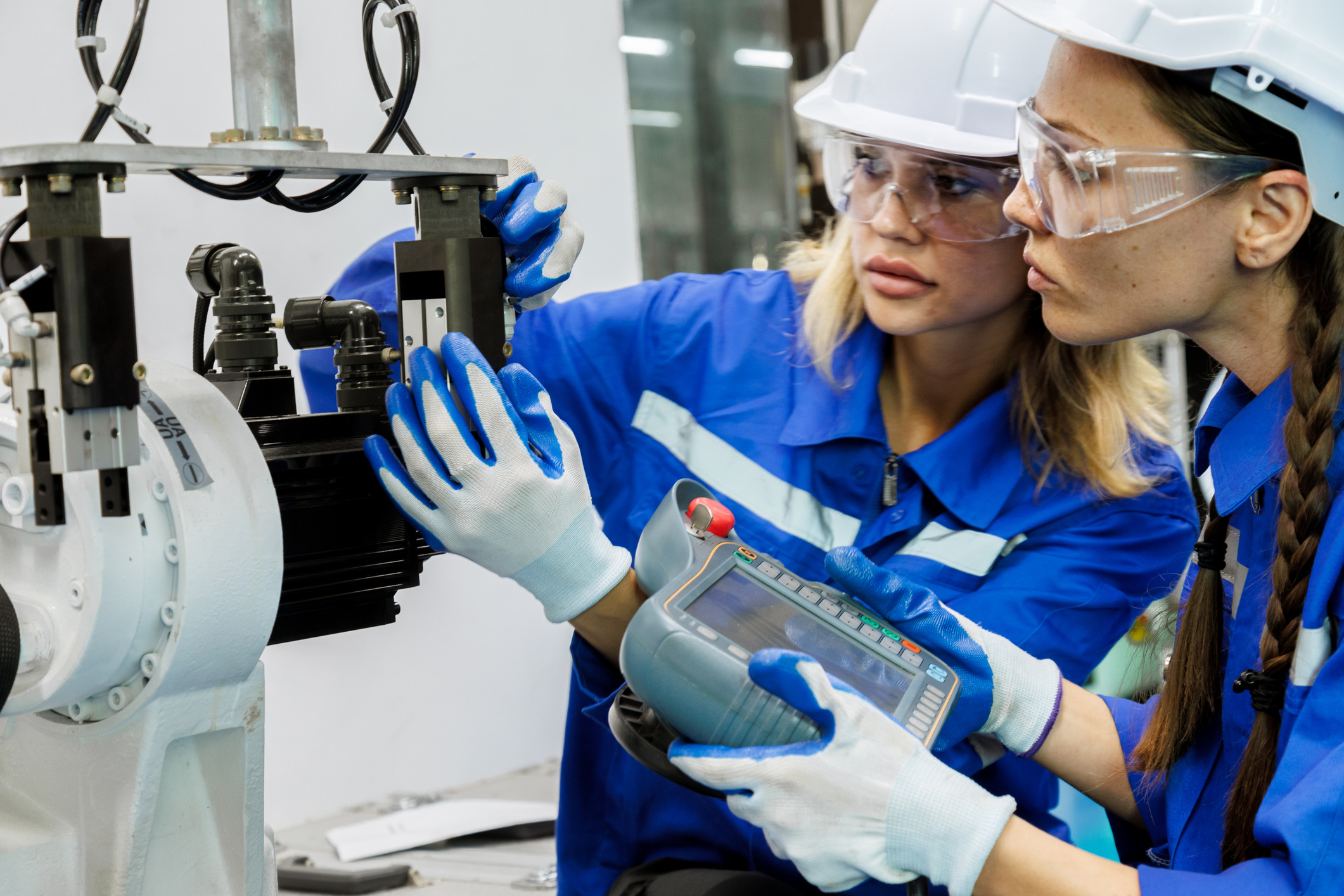 engineers inspecting robotic equipment in a smart factory setting illustrating how mood aware environments use real time sensing and automation to support worker well being and performance under industry 5.0 principles