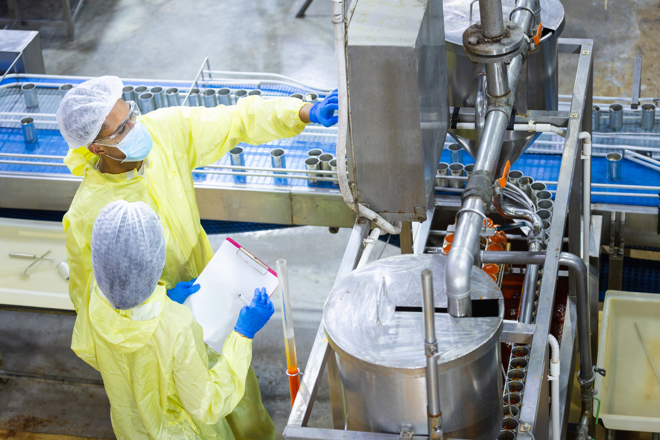 operations team inspecting an automated filling and packaging line at a food and beverage manufacturing facility, illustrating the operational readiness and process discipline required before AI initiatives can deliver results